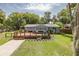 Quaint home boasting a large wooden deck and a well-maintained front lawn at 7424 Grand Blvd, New Port Richey, FL 34652