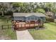 Charming home featuring a spacious deck, outdoor seating, and a landscaped front yard at 7424 Grand Blvd, New Port Richey, FL 34652