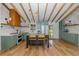 Charming kitchen featuring custom green cabinets, wood beams, and a butcher block island at 7424 Grand Blvd, New Port Richey, FL 34652