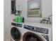 Laundry room featuring modern washer and dryer appliances and a window unit at 7424 Grand Blvd, New Port Richey, FL 34652
