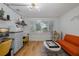 Bright living room area with hardwood flooring and large windows at 7424 Grand Blvd, New Port Richey, FL 34652