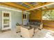 Covered patio with wicker seating, offering an inviting outdoor space for relaxation and entertaining at 7424 Grand Blvd, New Port Richey, FL 34652