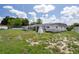 View of the home's backyard with a covered structure and side yard, offering privacy and space at 7608 Dale Dr, Port Richey, FL 34668