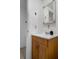 Bathroom features a single sink vanity with framed mirror and tiled flooring at 7608 Dale Dr, Port Richey, FL 34668