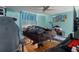 Bedroom features a queen sized bed frame, ceiling fan and hardwood flooring at 7608 Dale Dr, Port Richey, FL 34668