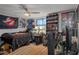 Eclectic bedroom with ceiling fan, Ghostbusters theme, and laminate floors at 7608 Dale Dr, Port Richey, FL 34668