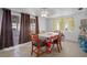 Dining room features a dining table, four chairs, window and glass sliding doors at 7608 Dale Dr, Port Richey, FL 34668