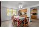 Dining room features a dining table, four chairs, window and open access to the kitchen at 7608 Dale Dr, Port Richey, FL 34668