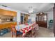 Dining room features a dining table, four chairs, view of the kitchen and a china cabinet at 7608 Dale Dr, Port Richey, FL 34668