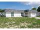 Single-story home featuring a gray shingle roof, stucco walls, and a one-car garage at 7608 Dale Dr, Port Richey, FL 34668