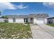 Charming single-story home with a driveway leading to an attached one car garage at 7608 Dale Dr, Port Richey, FL 34668