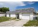 Well-kept single-story home featuring an attached garage and mature landscaping at 7608 Dale Dr, Port Richey, FL 34668