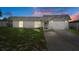 Inviting single-story home, well-lit with a charming front yard and attached garage at 7608 Dale Dr, Port Richey, FL 34668
