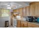 A traditional kitchen featuring wood cabinetry, laminate countertops, and an electric range oven at 7608 Dale Dr, Port Richey, FL 34668