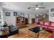 Cozy living room with hardwood floors, ceiling fan, and an electric fireplace at 7608 Dale Dr, Port Richey, FL 34668