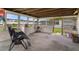 Enclosed sun room with multiple windows and outdoor access at 7608 Dale Dr, Port Richey, FL 34668
