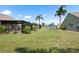 Scenic backyard view featuring a screened-in lanai, and views of the surrounding lake at 7923 Woburn St, New Port Richey, FL 34653