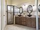 Luxurious Primary bathroom with double sinks, custom vanities, and a walk-in shower at 7923 Woburn St, New Port Richey, FL 34653