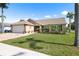Charming single-story home with a well-manicured lawn and attached two-car garage at 7923 Woburn St, New Port Richey, FL 34653
