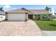 Charming single-story home featuring a brick driveway and attached two-car garage at 7923 Woburn St, New Port Richey, FL 34653