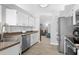Kitchen with updated appliances, stainless steel sink and white cabinetry at 7923 Woburn St, New Port Richey, FL 34653
