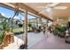 Inviting screened-in lanai offers views of the landscaped yard and features a ceiling fan for comfortable outdoor living at 7923 Woburn St, New Port Richey, FL 34653