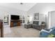 Spacious living room with hardwood floors, a fireplace, and natural light from the backyard at 7923 Woburn St, New Port Richey, FL 34653