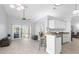 Open-concept room showing the living room and kitchen with wood floors and bar seating at 7923 Woburn St, New Port Richey, FL 34653