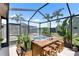 Screened-in pool and spa with well-kept patio and view of a lush green backyard at 7923 Woburn St, New Port Richey, FL 34653