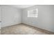 Bedroom with neutral walls, neutral flooring, and a bright window at 8053 Dedham Dr, Port Richey, FL 34668