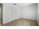 Bedroom with neutral walls, neutral flooring, closet, and adjacent bathroom at 8053 Dedham Dr, Port Richey, FL 34668
