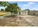 Modest single-story home with a small yard, partial stone ground cover, and mature shade tree at 8053 Dedham Dr, Port Richey, FL 34668
