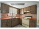Functional kitchen with retro-style appliances, wood cabinets, and a neutral color palette at 8053 Dedham Dr, Port Richey, FL 34668