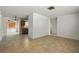 Open concept living room with tile flooring leading into the adjacent kitchen at 8053 Dedham Dr, Port Richey, FL 34668
