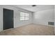 Bright living room featuring tile flooring, neutral walls, and natural light from the window at 8053 Dedham Dr, Port Richey, FL 34668