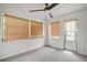 Bright sunroom with neutral walls, carpeted flooring, and abundant natural light from multiple windows at 8053 Dedham Dr, Port Richey, FL 34668