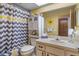 Cozy bathroom featuring stylish curtains, a vanity with sink, and a flower mirror at 8914 Schrader Blvd, Port Richey, FL 34668