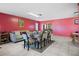Open-plan dining area with a large table and tiled floors and a sitting area in the background at 8914 Schrader Blvd, Port Richey, FL 34668