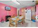 Compact dining table area with small fridge and lots of wood cabinets at 8914 Schrader Blvd, Port Richey, FL 34668