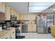 Well-lit kitchen featuring stainless steel appliances, ample counter space, and tiled flooring at 8914 Schrader Blvd, Port Richey, FL 34668