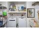 Functional laundry room with modern washer and dryer, shelving, and utility sink at 8914 Schrader Blvd, Port Richey, FL 34668