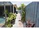 Landscaped backyard walkway with stone pavers and white gravel alongside a wooden fence at 9003 Lido Ln, Port Richey, FL 34668
