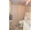 Bathroom featuring vanity, toilet, and shower with tile and neutral color palette at 9003 Lido Ln, Port Richey, FL 34668