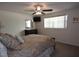 Bedroom with large window, ceiling fan, and a decorative mirror above the dresser at 9003 Lido Ln, Port Richey, FL 34668