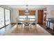 Dining room showcasing stylish chandelier, seating, and natural light at 9003 Lido Ln, Port Richey, FL 34668