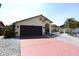 Charming home exterior featuring a two-car garage, terracotta tile roof and meticulous landscaping at 9003 Lido Ln, Port Richey, FL 34668