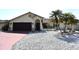 Inviting home exterior with a two-car garage, terracotta tile roof, and well-kept yard at 9003 Lido Ln, Port Richey, FL 34668