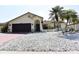 Charming single-story home features decorative stucco work, desert landscaping, and a two car garage at 9003 Lido Ln, Port Richey, FL 34668