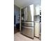 Stainless steel refrigerator in kitchen with white cabinets and stainless steel appliances at 9003 Lido Ln, Port Richey, FL 34668