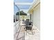 A cozy outdoor patio area features wrought iron furniture, a privacy screen, and pavers at 9003 Lido Ln, Port Richey, FL 34668